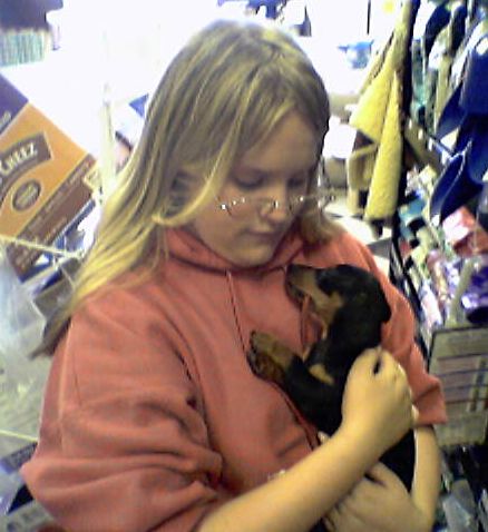 [Picture of Alyssa with a dachsund puppy]